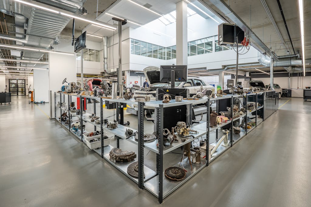 Spacious auto workshop showcasing various car parts and repair equipment.